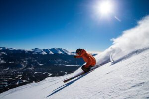 A man downhill skiing 