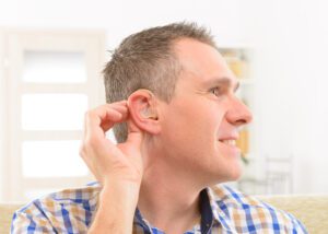 A man with hearing loss wearing a hearing aid