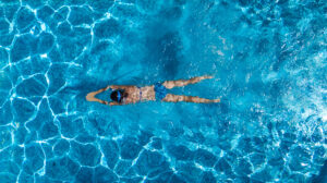 a woman swimming laps in a pool