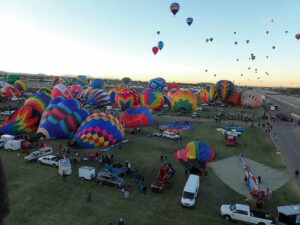 A hot air balloon festival, with dozens of balloons taking off