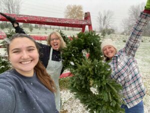 Three women purchase christmas wreathes in Fairfield County