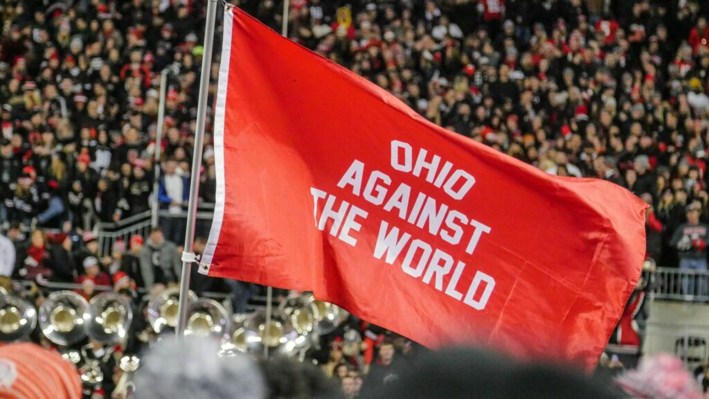 A large banner saying Ohio Against The World being waved at an Ohio State Football game.